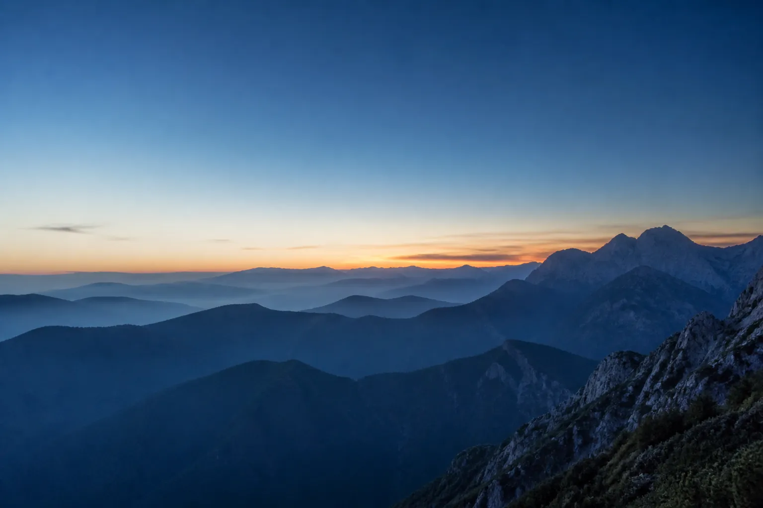 Layered mountain ridges at blue hour, representing a strong foundation for the next stage of growth
